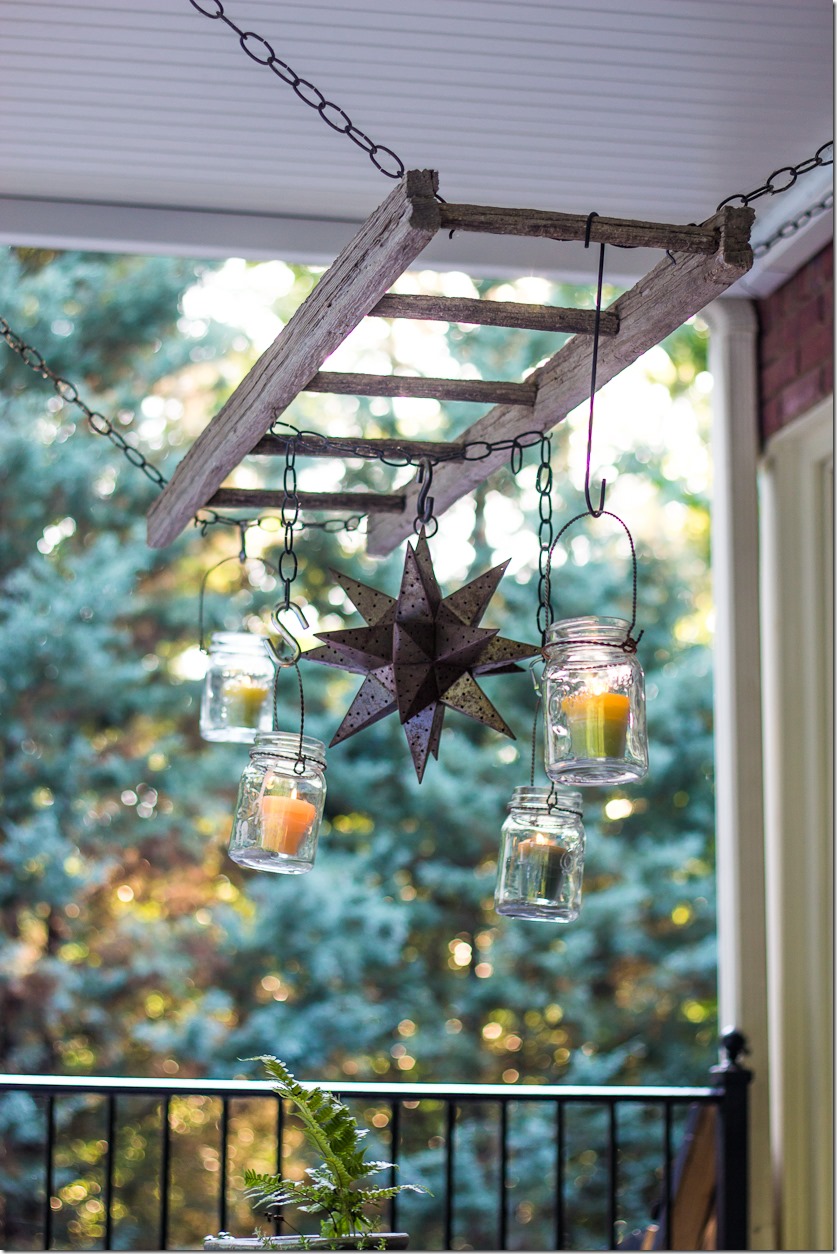 Use a ladder and mason jars for lighting over a patio table