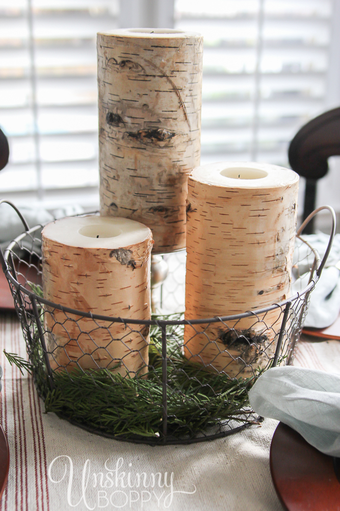 Birch Log candles in a wire basket make a simple holiday tablescape