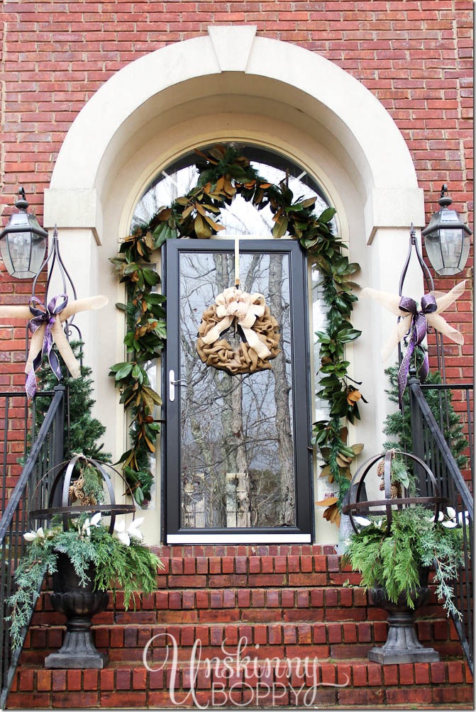 Gorgeous Christmas decorations on a front porch. Magnolias and urns filled with greenery