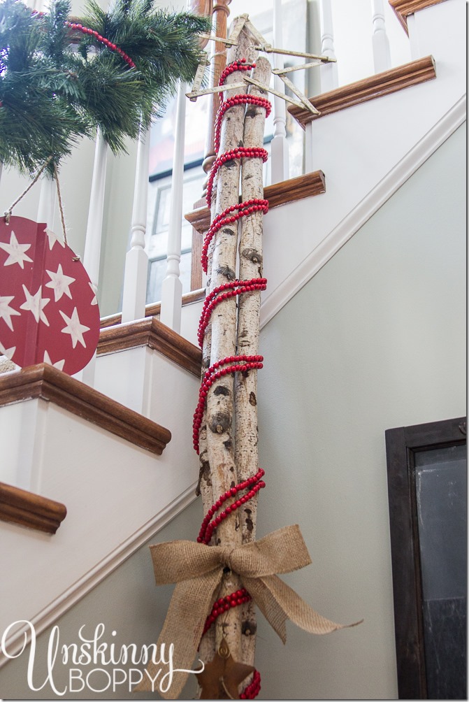 Wrap cranberry garland around birch logs for a candy cane effect. Cute!