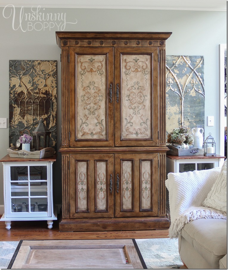 Love these white end tables on either side of this vintage armoire! Such simple decorations can bring together the look of a room.