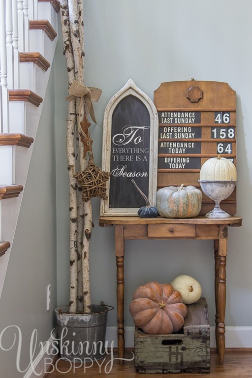 Old church attendance sign with birch logs and pumpkins