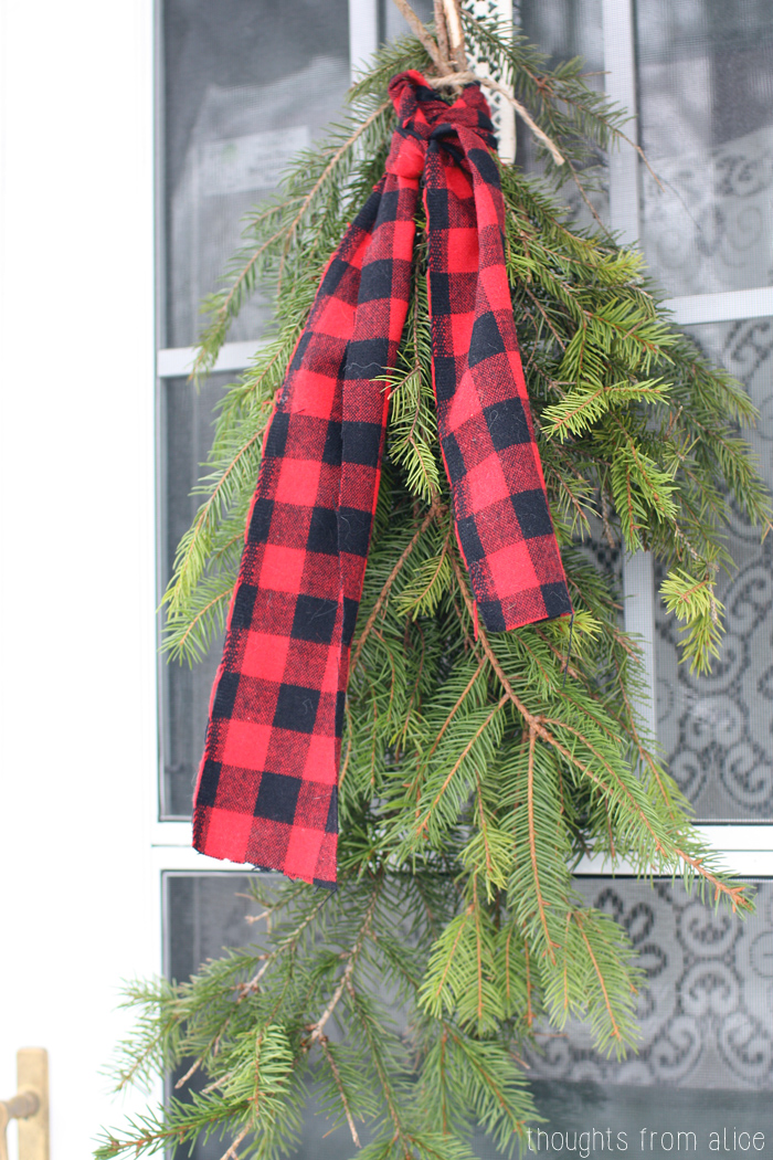 Evergreen-Boughs-with-Plaid-Door-Wreath