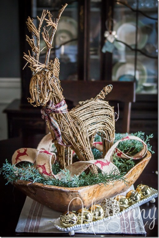 Dough bowl with a twig reindeer and greenery- simple centerpiece idea. 