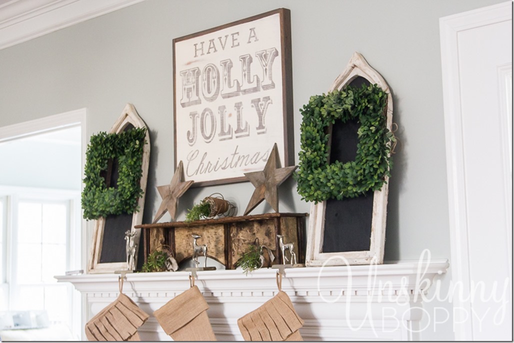 Boxwood wreaths on a chalkboard.