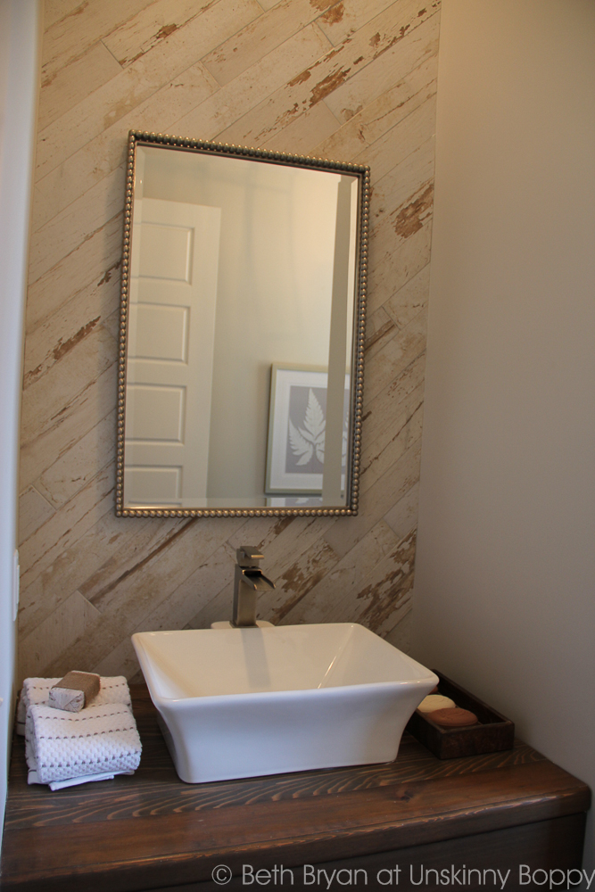 Think this is reclaimed wood? Think again. It's tile! Birmingham Parade of Homes Decor Ideas - bathroom backsplash. 