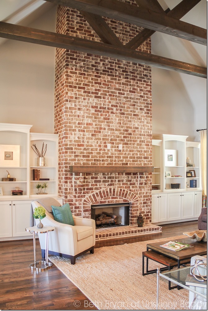 Fireplace in vaulted ceiling with wooden beams. 2015 Birmingham Parade of Homes built by Murphy Home Builders 