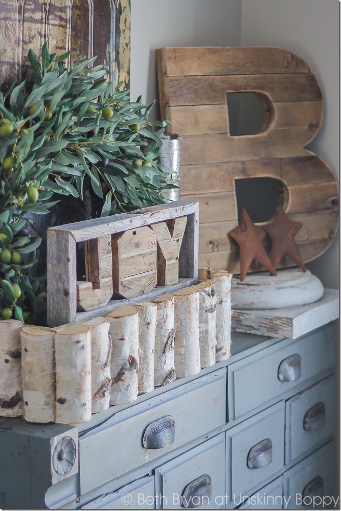 Pretty light blue apothecary cabinet.  Love that wooden B and the birch log basket, too.