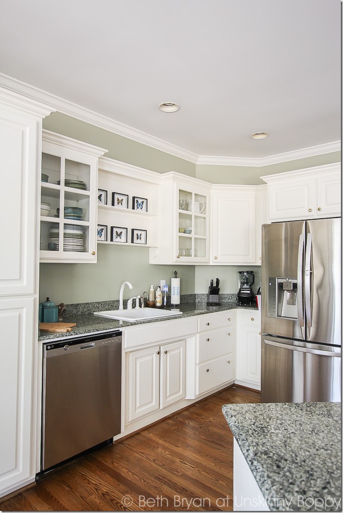 White kitchen with green granite counters and stainless steel