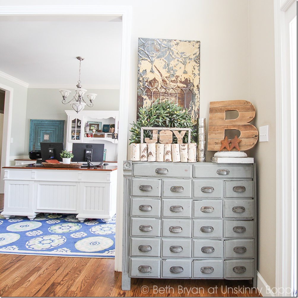 Pretty light blue apothecary cabinet.  Love that wooden B and the birch log basket, too.