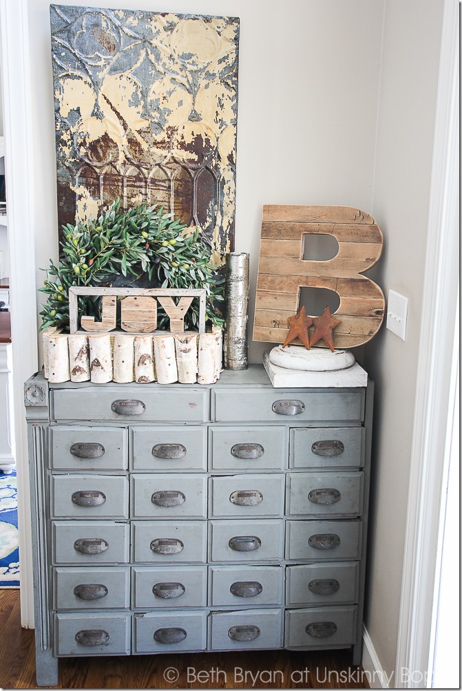 Pretty light blue apothecary cabinet.  Love that wooden B and the birch log basket, too.