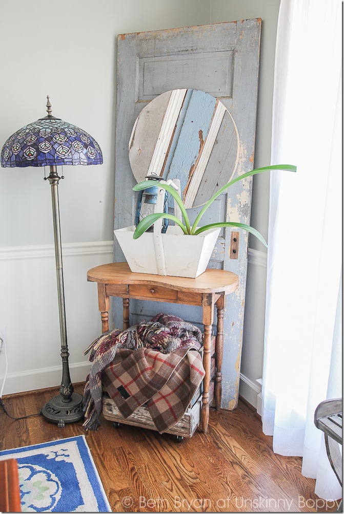 Love this idea-wooden door in the corner with a small table and pretty tiffany style lamp