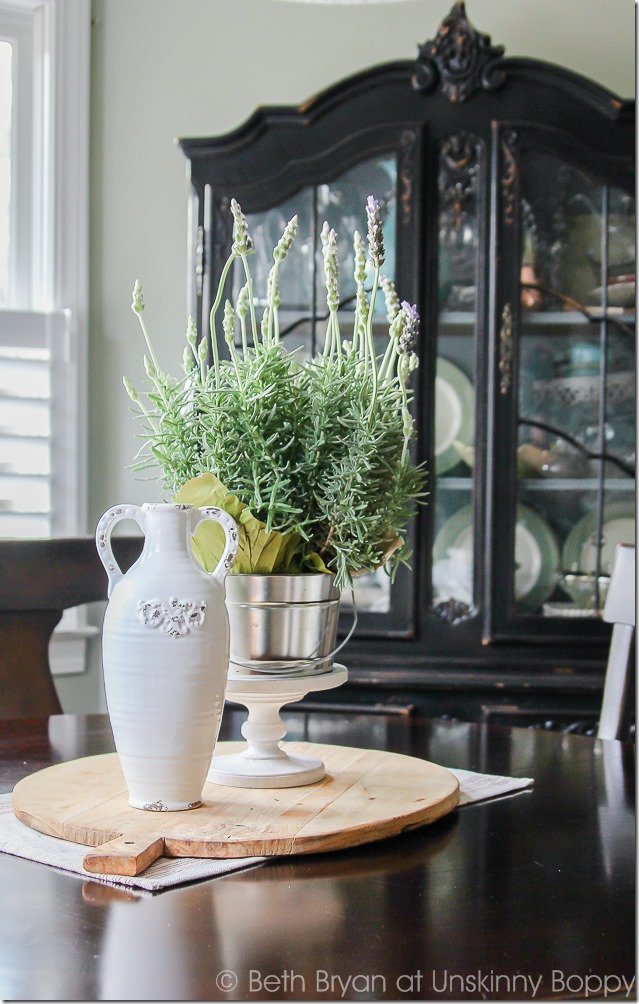 Kitchen table decor on a bread board. So pretty! Lavender in a bucket with a white vase. Simple and gorgeous.