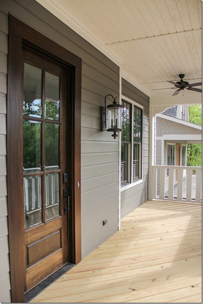 dark green siding with wood front door