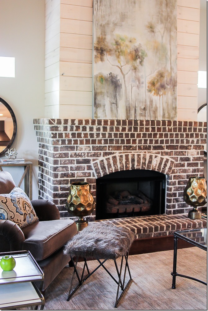 Who else loves the look of this traditional arched brick fireplace with shiplap above? #imafan #fireplacelove #fireplacedecor