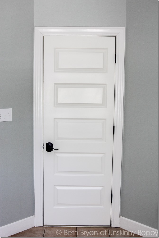 A shot of our new door in the master bathroom; adding this DIY door to the cased opening in our master bathroom was the perfect solution for privacy.