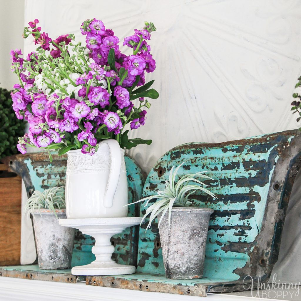 Old truck fenders turned upside down look like butterfly wings! Check out this unique and rustic mantel decor / Spring Home Tour by Unskinny Boppy