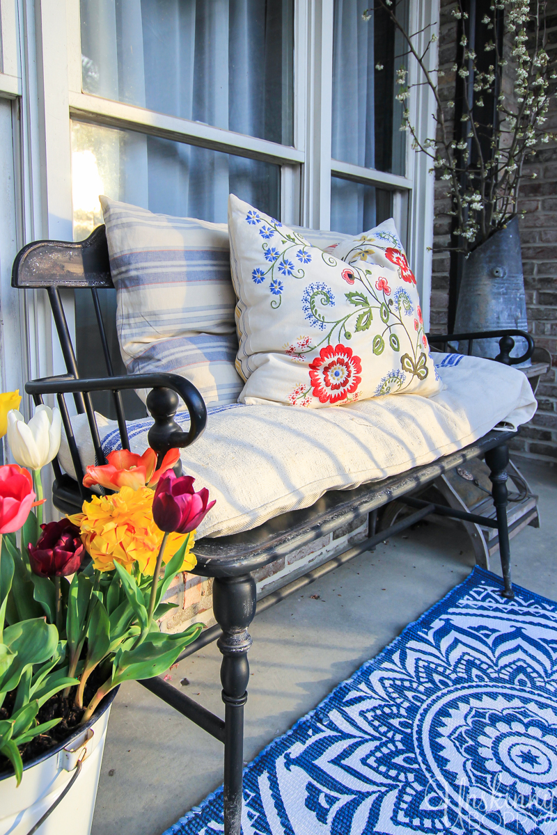 Freshen up the front porch for Spring with a new blue & white mandala rug from Homegoods and a bucket of tulips. 