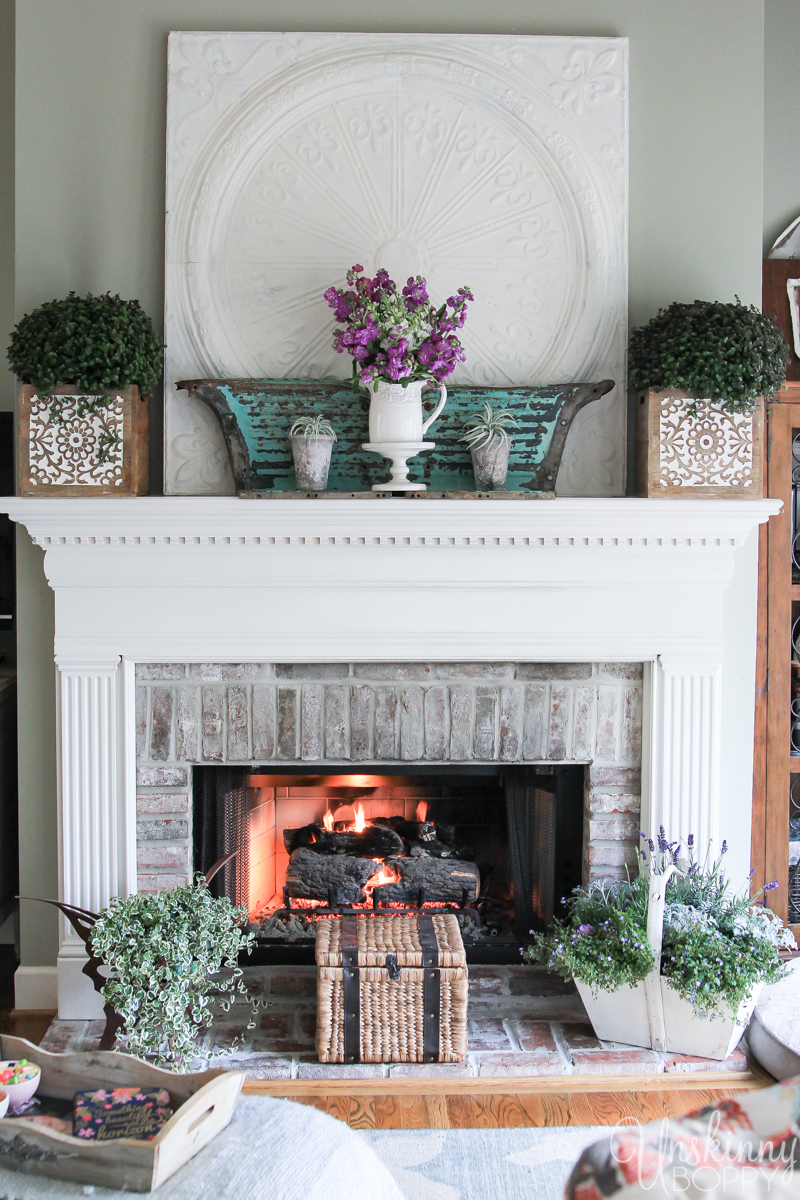 Fireplace mantel decorated for Spring- white/teal/purple theme. 