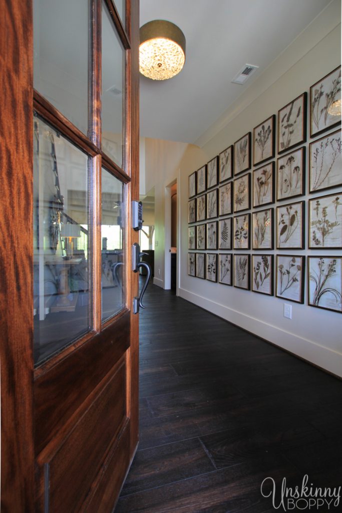 Wide entrance foyer with huge dried flower collage on wall