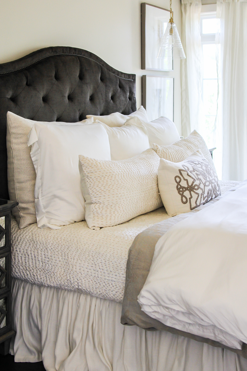 Padded brown headboard with ruffled bedskirt