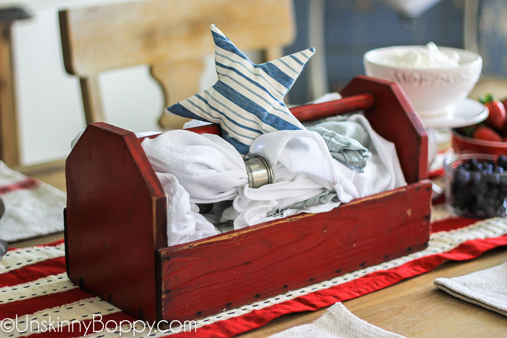 red tool box with white napkins and blue star ticking