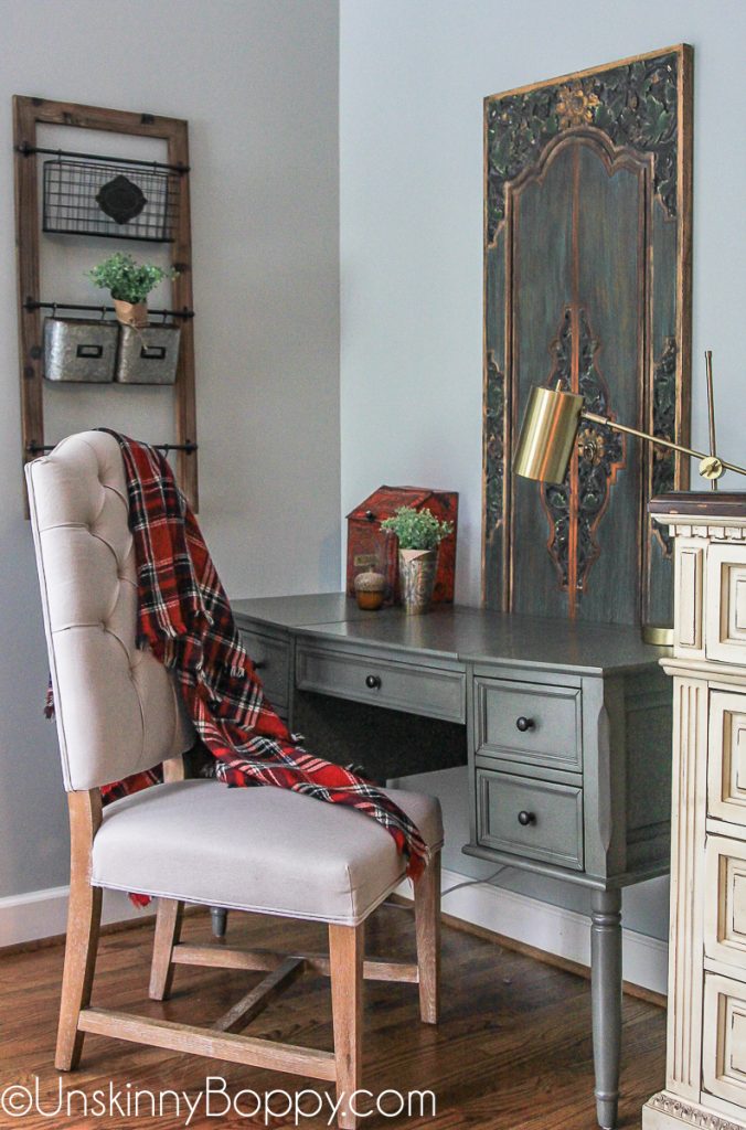 Green writing desk in corner of bedroom