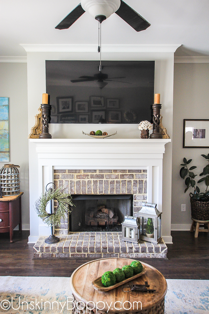 Springtime wreath and lanterns on a brick fireplace