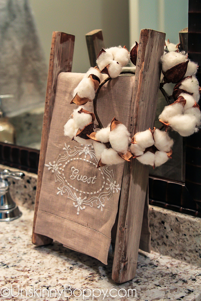 small cotton wreath on a guest towel ladder in bathroom