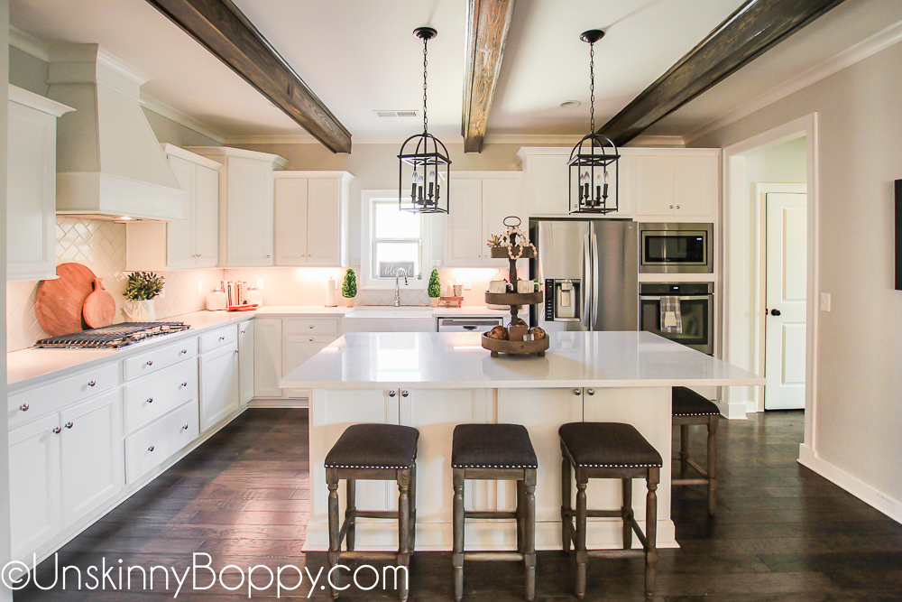 White kitchen with wooden beams