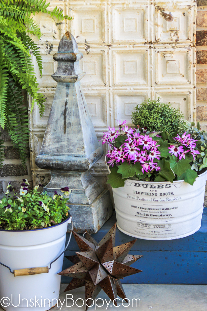 Front Porch Decor Ideas- flowers in white buckets, moravian star and garden finial