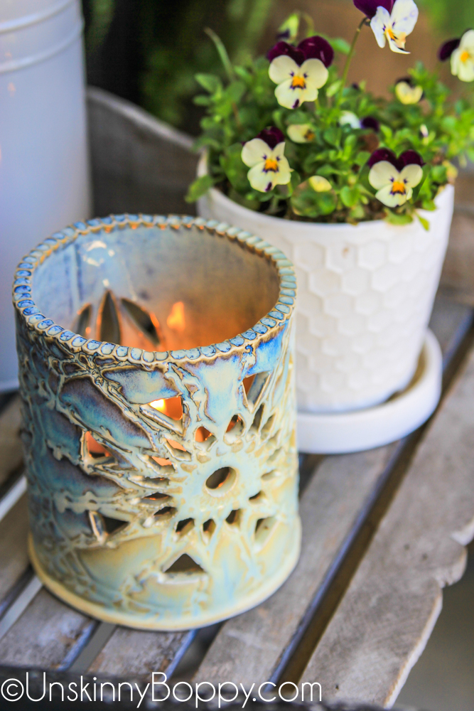 blue ceramic luminaria with viola flowers