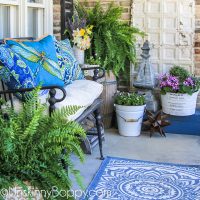 Narrow front porch decorated for summer