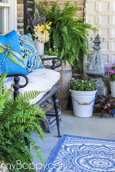 Narrow front porch decorated for summer