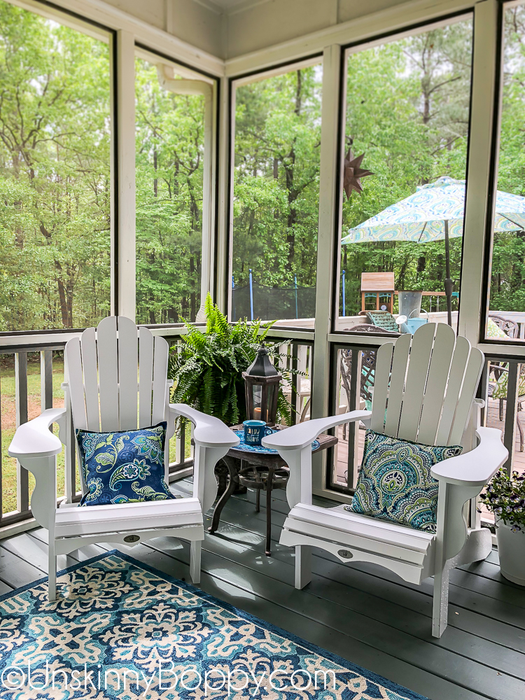 White adirondack chairs with blue and aqua rug