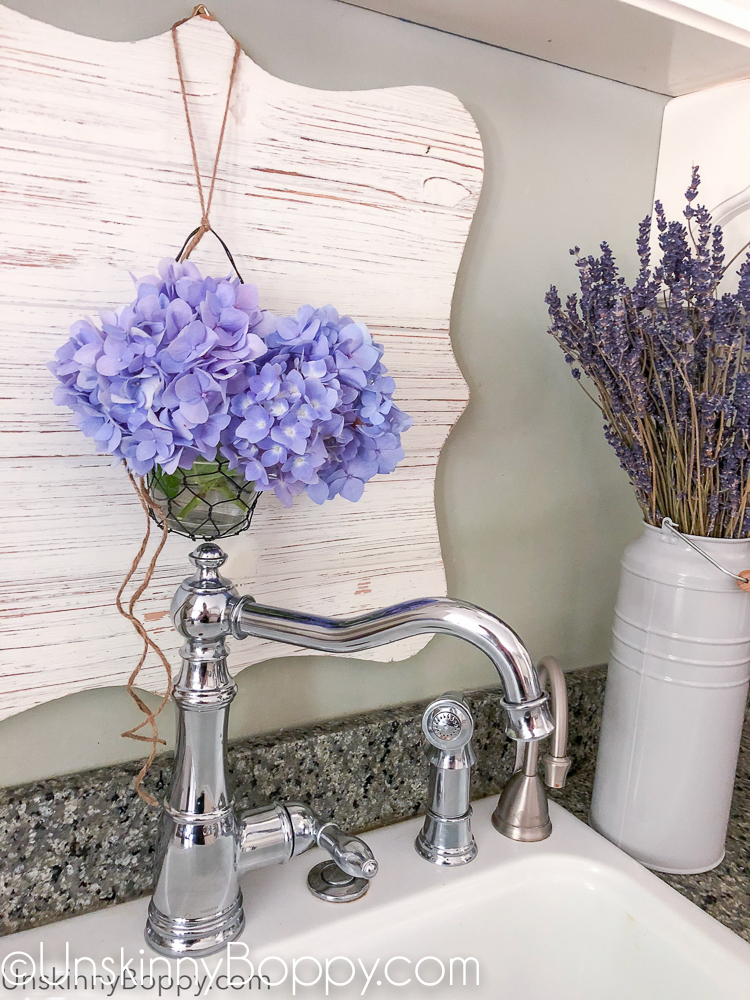 Periwinkle Hydrangea hanging above chrome faucet sink