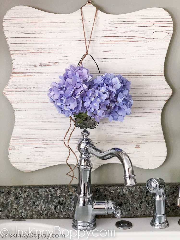 Periwinkle Hydrangea hanging above chrome faucet sink