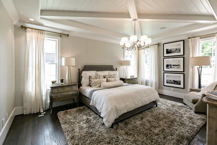 Bedroom with white shiplap ceiling and beams