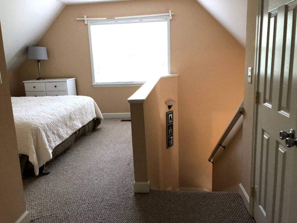 loft bedroom with clipped ceilings