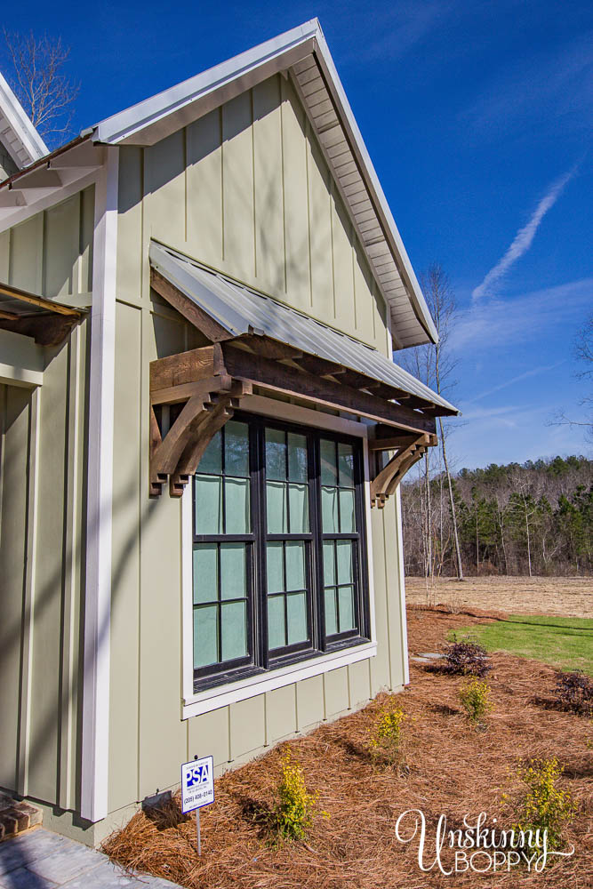 Metal shed roof with wood corbels and brackets, board and batten siding