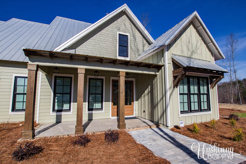 Front porch of modern farmhouse with tin roof