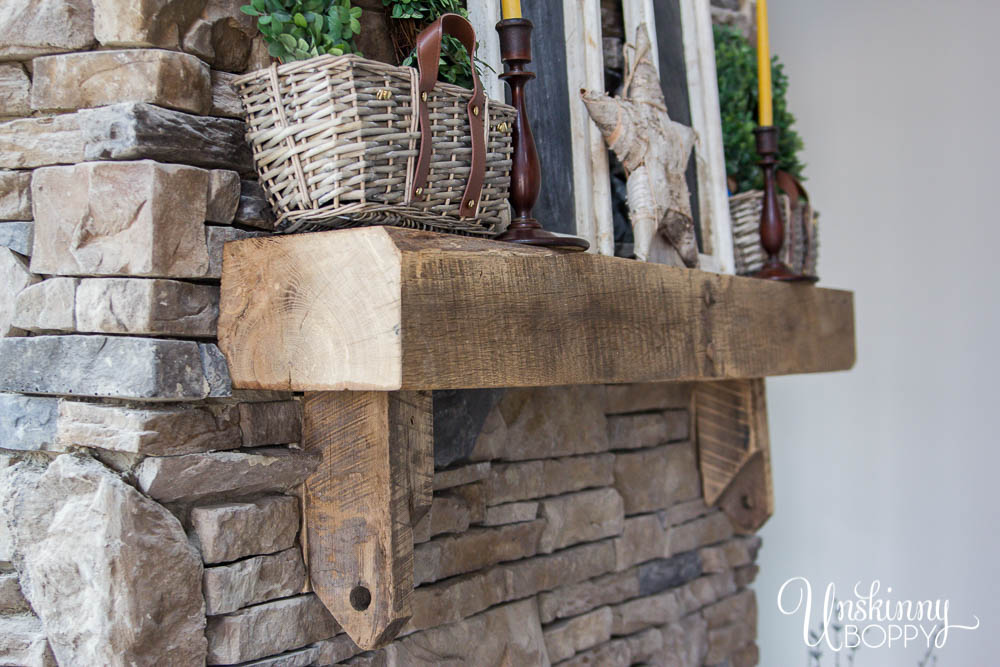 Hand-hewn mantel on rock fireplace