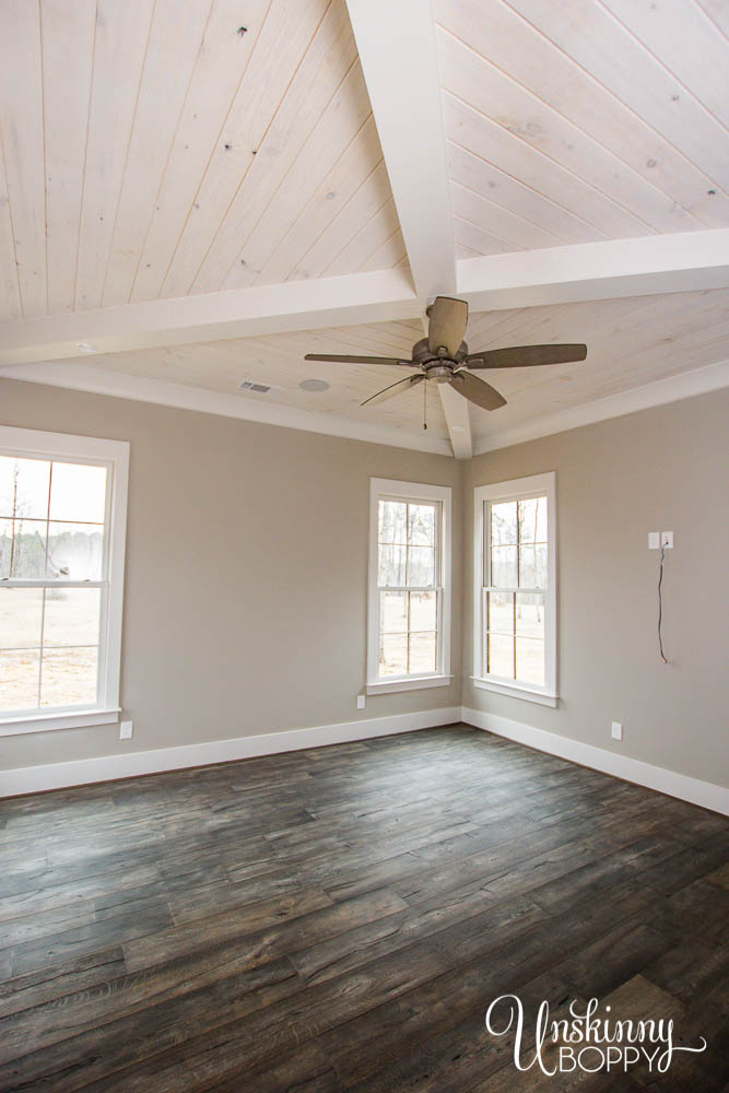 Master bedroom with X beam and whitewashed V-groove ceilings