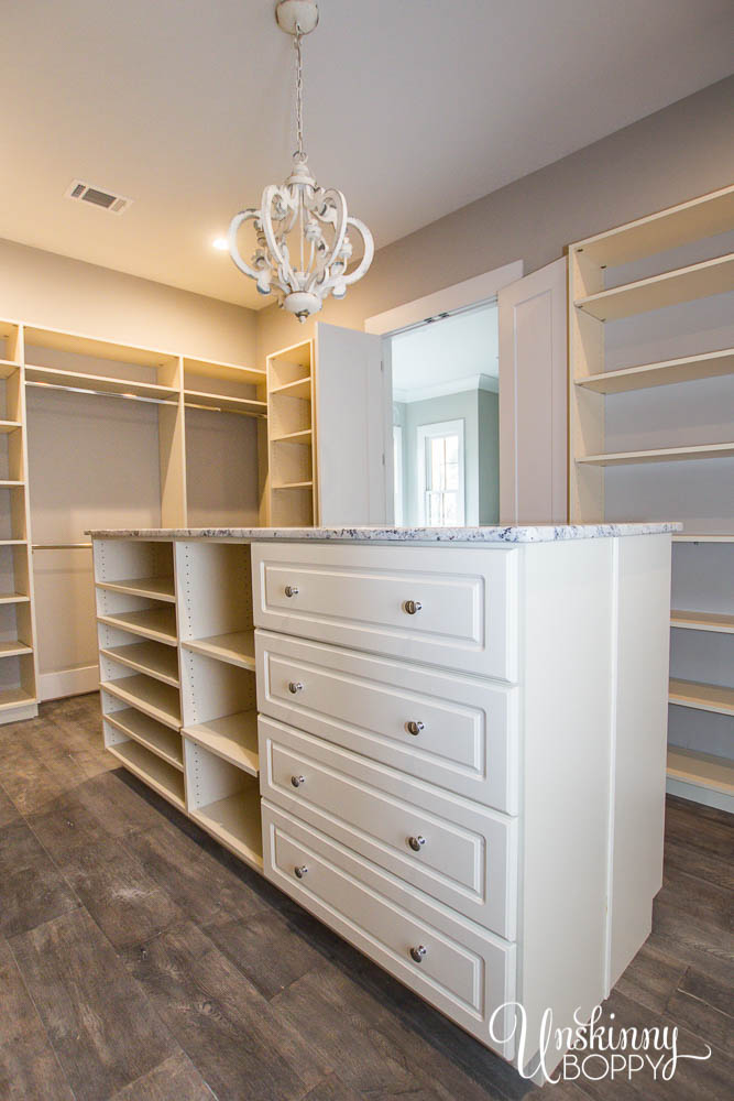 Huge Master closet with island storage