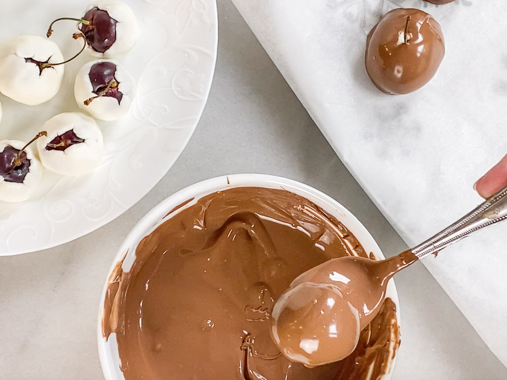 Roll the cherries in chocolate with a spoon