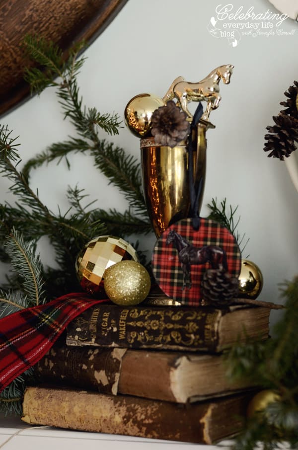 Vintage brass horse trophy with Ralph Lauren plaid on a stack of books