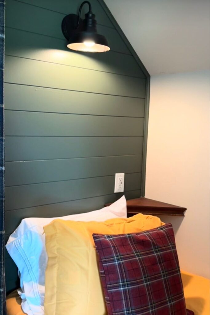 floating corner shelf installed inside attic bunk nook painted Sherwin-Williams Pewter Green for phone glasses and water bottle storage at each sleeping space