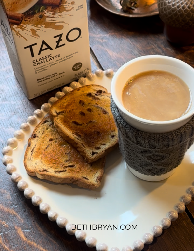 how to make starbucks copycat chai latte at home - wooden table with hot cup of chai on a plate with toast